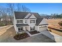 Elegant two-story home with landscaped yard, two car garage and beautiful architectural details at 1065 Kinship Dr # 080, Lancaster, SC 29720