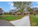 Ranch style home with a long driveway and mature trees at 130 Island Park Ln, Statesville, NC 28625