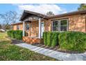 Brick ranch house with landscaped yard and a covered porch at 130 Island Park Ln, Statesville, NC 28625