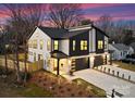 An aerial view of a modern two-story townhome at twilight, with lush landscaping at 2201 Catalina Ave, Charlotte, NC 28206