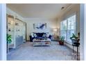 Cozy living room with bright window, plush seating, and elegant decor at 3848 Burnage Hall Rd, Harrisburg, NC 28075