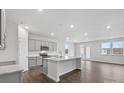 Open-concept kitchen with gray cabinets, stainless steel appliances, granite countertops, and a large island at 1133 Hallman Branch Ln, Lincolnton, NC 28092
