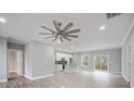 Spacious open-concept living area showcases a modern ceiling fan, recessed lights, and a seamless flow into the kitchen at 3007 Buffett Ln, Monroe, NC 28110