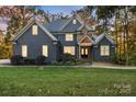 Charming exterior view of two-story home with stone and blue siding at 3853 Gordon St, Terrell, NC 28682