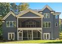 View of the home's rear exterior, featuring a screened-in porch and well-maintained lawn at 3853 Gordon St, Terrell, NC 28682
