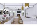 Open concept living area with a gourmet kitchen, living room with fireplace, and access to the outdoors at 428 Dover Ave, Charlotte, NC 28209