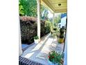 Charming front porch featuring a stylish rug, potted plants, and a cozy seating area at 13112 Appolinaire Dr, Davidson, NC 28036