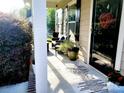 Inviting front porch with comfortable seating, decorative plants, and shade from the sun at 13112 Appolinaire Dr, Davidson, NC 28036
