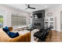 Bright and airy living room with a fireplace and large windows at 15126 Sustar Farm Dr # 36, Matthews, NC 28105