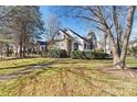 Brick ranch home with a white porch and landscaped yard at 20109 Norman Colony Rd, Cornelius, NC 28031