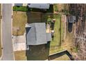 Aerial view of a home with a spacious backyard, wooden deck, play set, shed, and fenced in yard at 7520 Berkeley W Rd, Denver, NC 28037