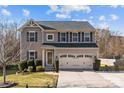 Charming two-story home with a well-maintained lawn, a two-car garage, and attractive curb appeal at 7520 Berkeley W Rd, Denver, NC 28037