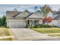 Charming one-story house with a two-car garage and manicured lawn at 1035 Crescent Moon Dr, Fort Mill, SC 29715