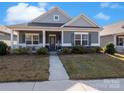 Charming single-story home with a covered front porch, well-maintained lawn, and welcoming curb appeal at 280 Kerri Dawn Ln, Locust, NC 28097