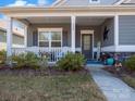Inviting front porch with ample seating and a welcoming entrance at 280 Kerri Dawn Ln, Locust, NC 28097