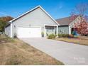 Spacious two-car garage with a concrete driveway and partial view of the house at 280 Kerri Dawn Ln, Locust, NC 28097