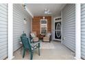 Inviting covered front porch with neutral furniture, ceiling fan, and brick accents at 284 Garnet Ct, Fort Mill, SC 29708