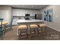 Modern kitchen with white cabinets, island, and stainless steel appliances at 4011 Bufflehead Dr, Charlotte, NC 28269