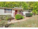A single story home with a well-manicured front yard and playground in the backyard at 5320 Liberty Hill W Rd, York, SC 29745