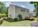Spacious backyard featuring a deck, fence, and lush green lawn, perfect for outdoor entertaining at 14027 Grand Traverse Dr, Charlotte, NC 28278