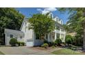 Beautiful home with a two-story porch, well-maintained landscaping, and a driveway with a basketball hoop at 14027 Grand Traverse Dr, Charlotte, NC 28278