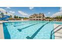 The community pool showcases a large swimming area, a waterslide, and a spacious lounge area, perfect for recreation at 14027 Grand Traverse Dr, Charlotte, NC 28278
