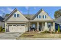 Two-story home with front porch, landscaping, and attached two-car garage at 14535 Crosswater Ln, Charlotte, NC 28278