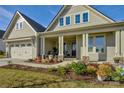 Two-story house with a front porch and landscaped yard, attached two-car garage at 14535 Crosswater Ln, Charlotte, NC 28278