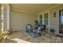 Relaxing front porch with stone flooring and wicker furniture at 14535 Crosswater Ln, Charlotte, NC 28278