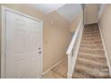 Front entry with staircase and neutral carpeting at 7141 Stonington Ln, Charlotte, NC 28227