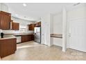 Bright kitchen featuring stainless steel appliances, granite counters, and tile flooring at 14423 Glendon Hall Ln, Charlotte, NC 28262