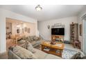 Spacious living room with comfortable seating and a view into the dining area at 14423 Glendon Hall Ln, Charlotte, NC 28262