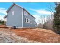 Side view of the house showcasing blue siding and backyard at 2668 Polo Ln, Maiden, NC 28650