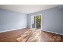 Light-filled bedroom with hardwood floors and access to a private patio at 2705 North Center St # 74, Hickory, NC 28601