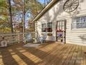 Relaxing deck area featuring seating and charming decor, perfect for outdoor enjoyment at 294 Carroll Cv, Clover, SC 29710