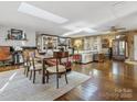 Spacious open-concept living and dining area with wood floors, natural light, and stylish furnishings at 294 Carroll Cv, Clover, SC 29710