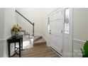 Bright entryway with staircase, wood floors, and decorative accents at 5580 Berry Ridge Dr, Harrisburg, NC 28075