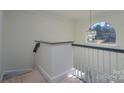 Elegant staircase with a modern handrail and neutral color palette at 5580 Berry Ridge Dr, Harrisburg, NC 28075