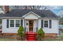 Front view of a white house with red steps and landscaping at 1235 10Th Ne St, Hickory, NC 28601