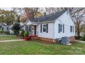 Side view of a white house with red steps and landscaping at 1235 10Th Ne St, Hickory, NC 28601