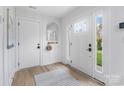 Bright, inviting entryway featuring wood-look flooring, a coat rack, and natural light at 2146 Barrowcliffe Nw Dr, Concord, NC 28027