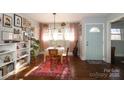 Bright dining area with hardwood floors and gallery wall at 2701 Palm Ave, Charlotte, NC 28205