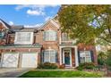 Two story brick home with a charming front entrance and landscaping at 7943 Oratorio Pl, Charlotte, NC 28270