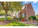 Side view of brick home showcasing landscaping and driveway at 7943 Oratorio Pl, Charlotte, NC 28270