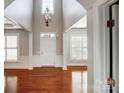 Bright foyer featuring a high ceiling, hardwood floors, and a chandelier at 7943 Oratorio Pl, Charlotte, NC 28270