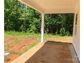 Covered back porch provides the perfect outdoor retreat overlooking a green backyard at 9130 Dulwich Dr # Ken0079, Charlotte, NC 28215