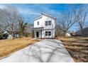 Charming two-story home with vertical siding and a concrete driveway at 1097 Georgetown Rd, Lincolnton, NC 28092