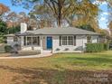 Front view of renovated white brick ranch at 201 Seneca Pl, Charlotte, NC 28210