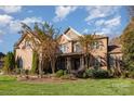 Two-story brick home with a front porch and landscaping at 3014 Highbury Pl, Weddington, NC 28104