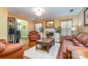 Spacious living room featuring hardwood floors, a fireplace, and leather furniture at 7546 Lady Liberty Ln, Charlotte, NC 28217